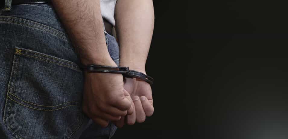 Man in handcuffs from criminal charges in Texas